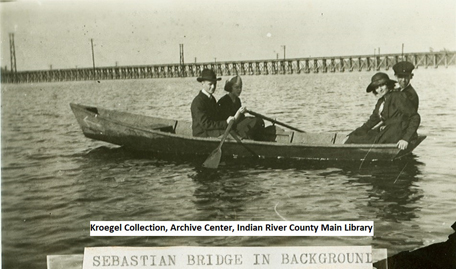Rodney Kroegel rowing boat on St. Sebastian River, origianl wooden bridge in background
